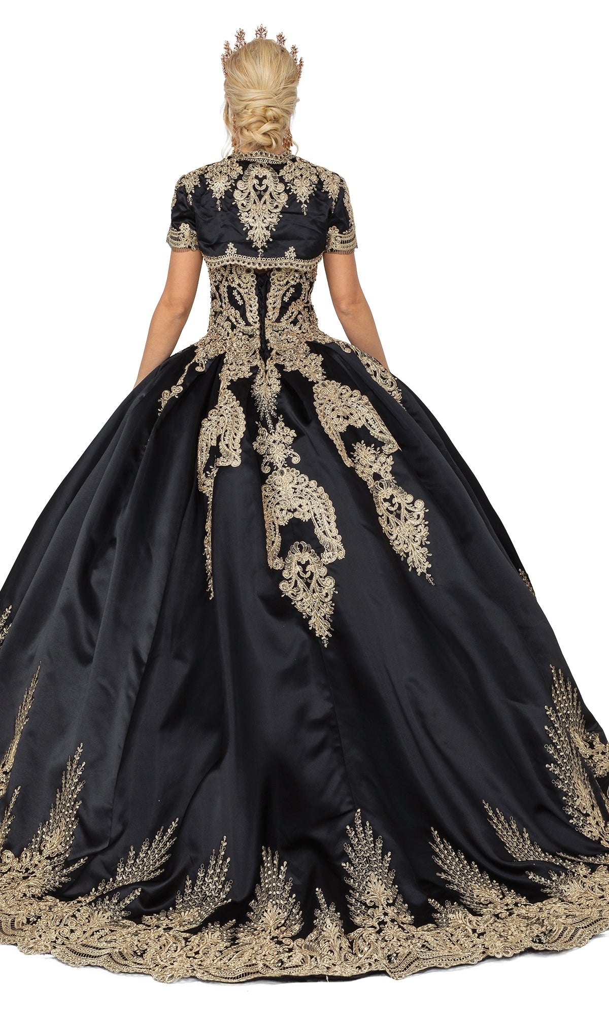 A person shown from the back, wearing Quinceanera Dress 1494 by Dancing Queen—an a-line ball gown with gold lace embroidery and a gold crown—against a white background.